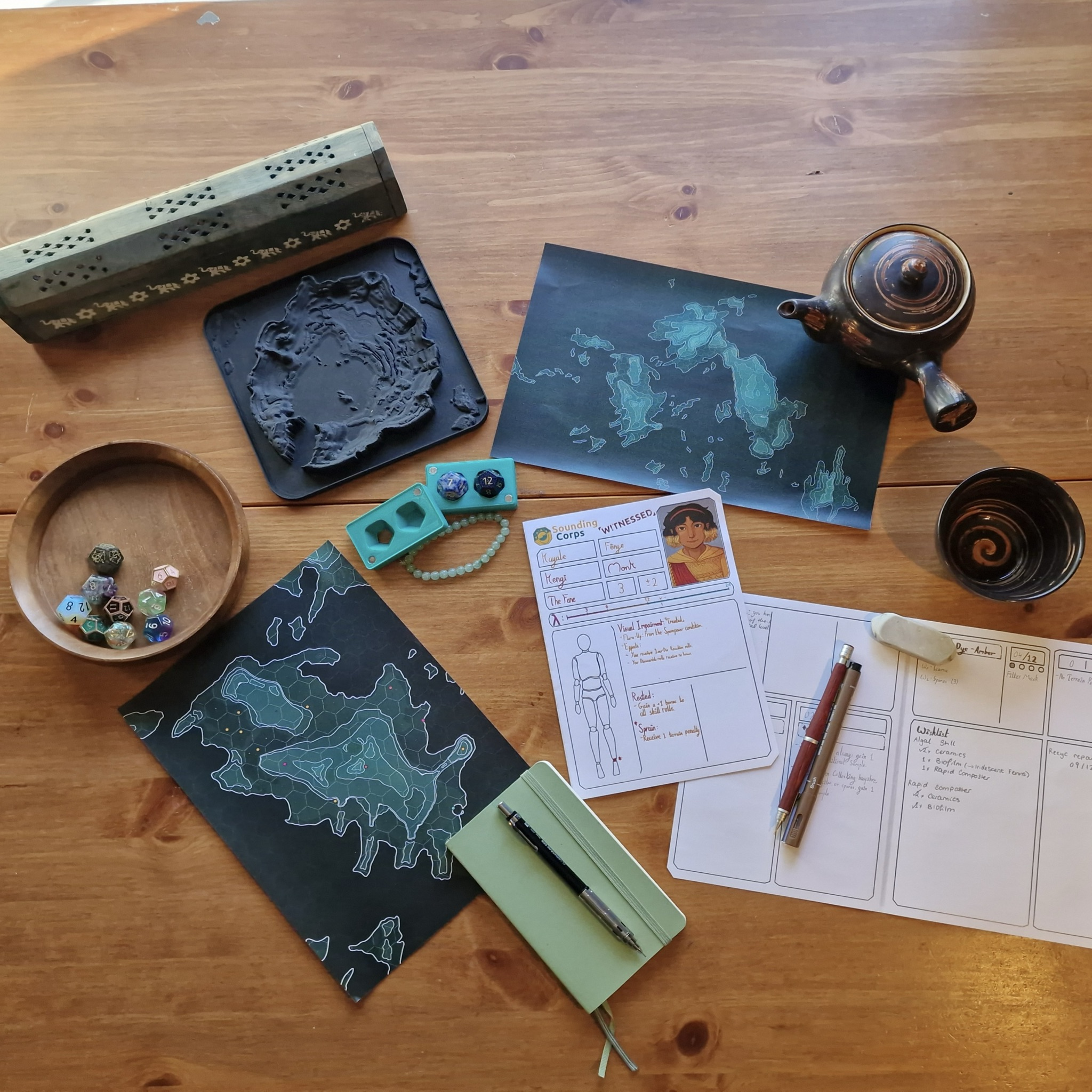 The key physical components of the game laid-out on a table. There 